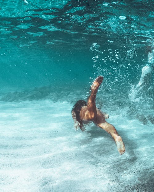 Free A Woman Swimming Under Water Stock Photo