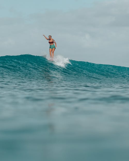A Woman Riding the Surfboard