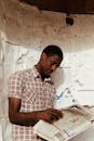 Thoughtful black man reading newspaper