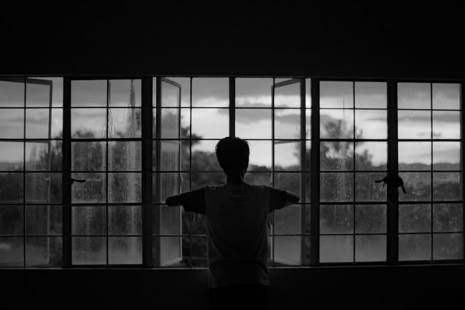 Silhouette of a person at a window — iboga demands honesty; it is not possible to take it ceremonially and avoid a direct encounter with what is actually present in your life
