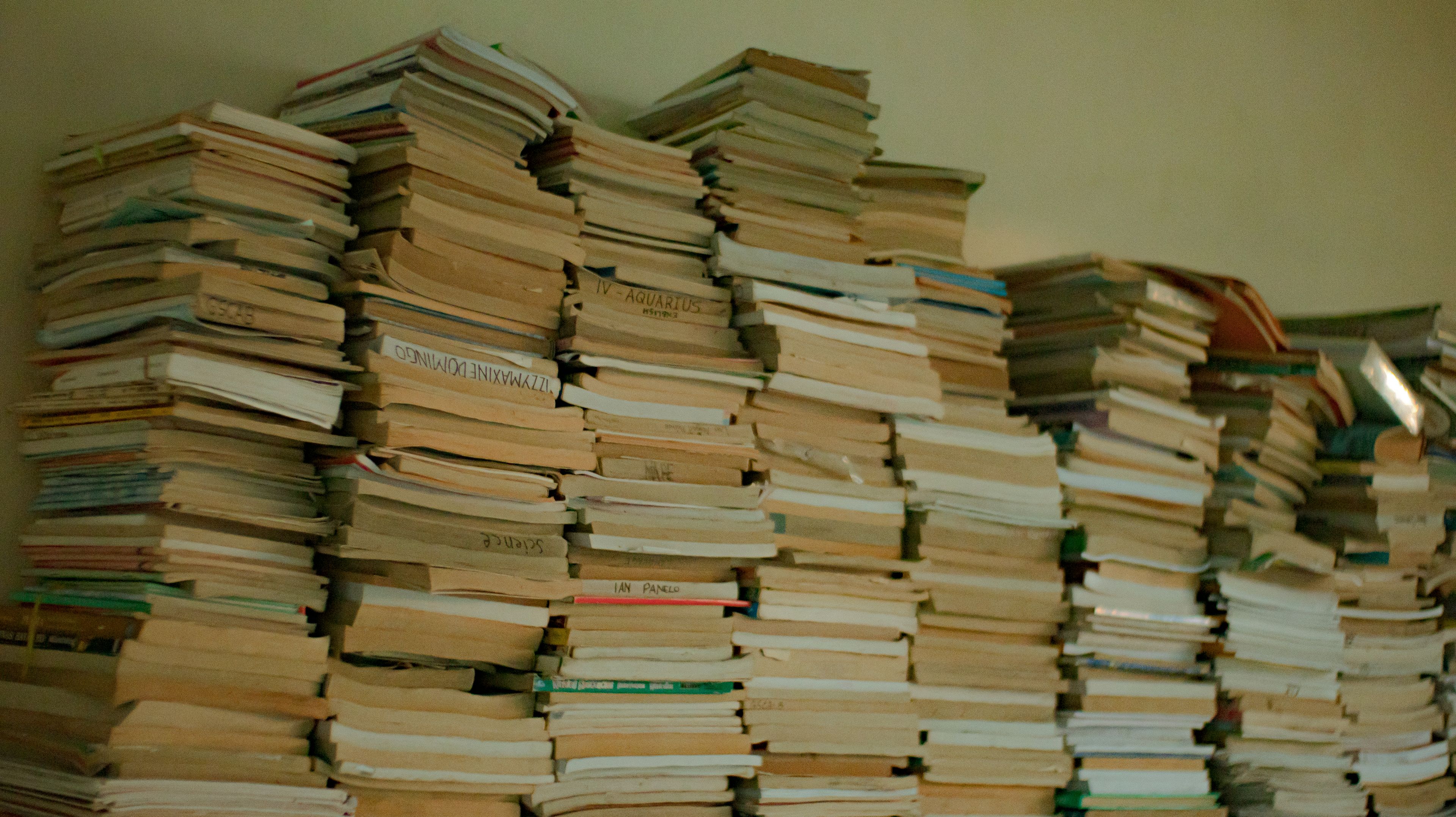 Stacks of well-worn second-hand books piled high