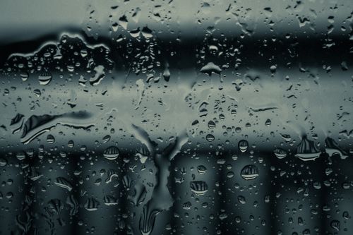 Free Moody image of raindrops on a glass window with blurred background. Stock Photo