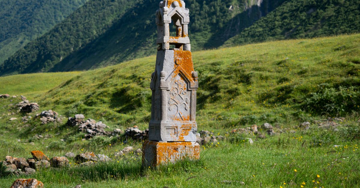 A historic stone monument in the lush mountainous landscape of Ketrisi, Georgia.