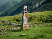 A historic stone monument in the lush mountainous landscape of Ketrisi, Georgia.