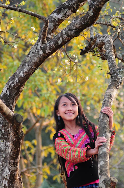 Portrait of Beautiful Girl Between Branches