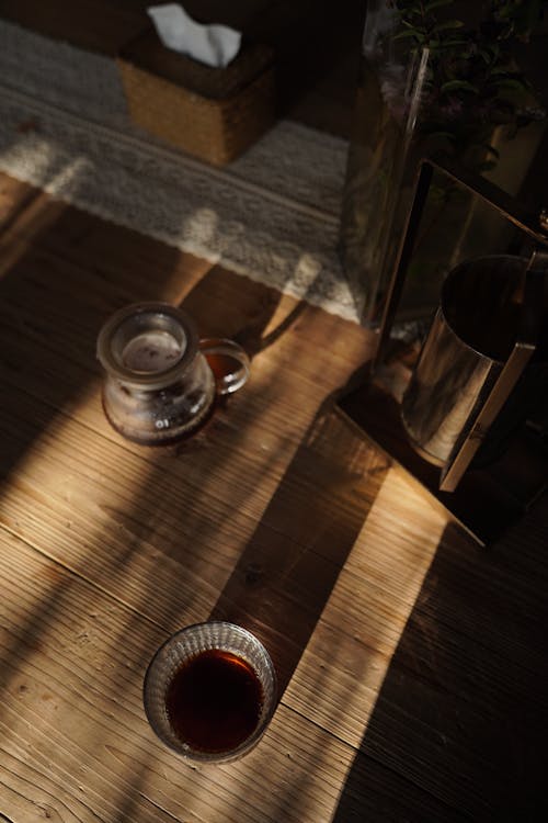 Top View of Glasses with Coffee on Wooden Table in Shadow