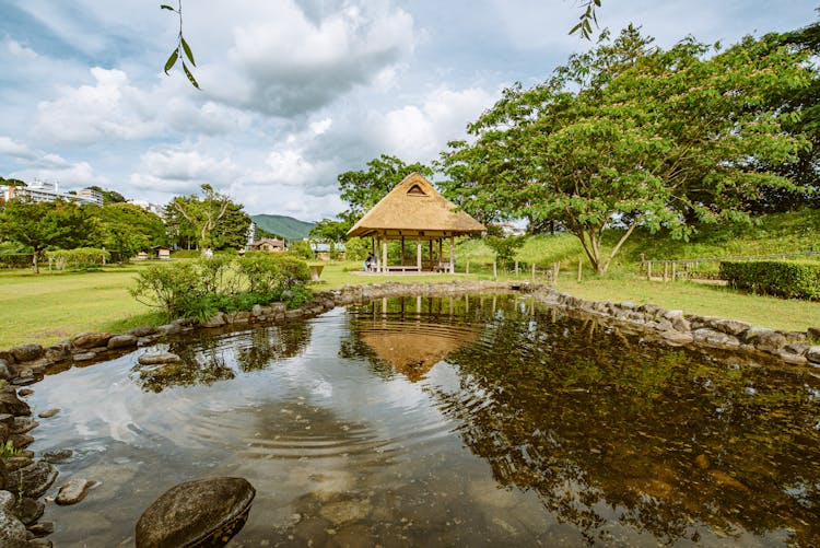 Garden With Bower Situated By Pond