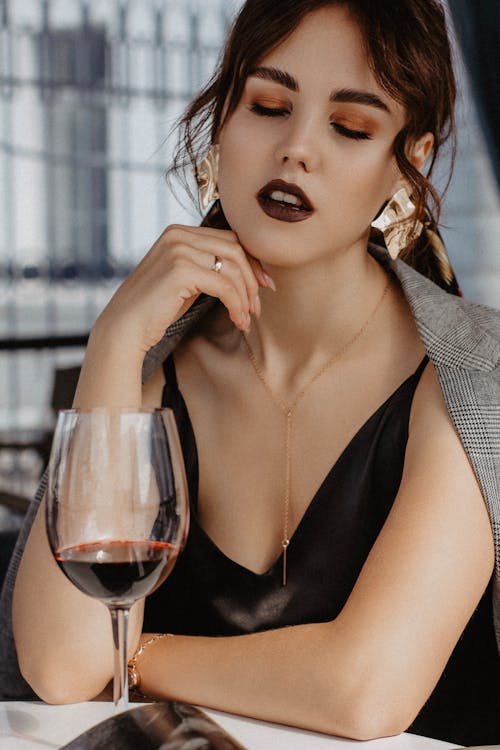 Free Alluring young lady chilling in restaurant with wineglass Stock Photo