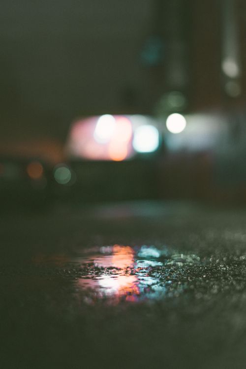 Free Abstract night scene in Perth with blurred city lights reflecting on a wet street, creating a moody atmosphere. Stock Photo