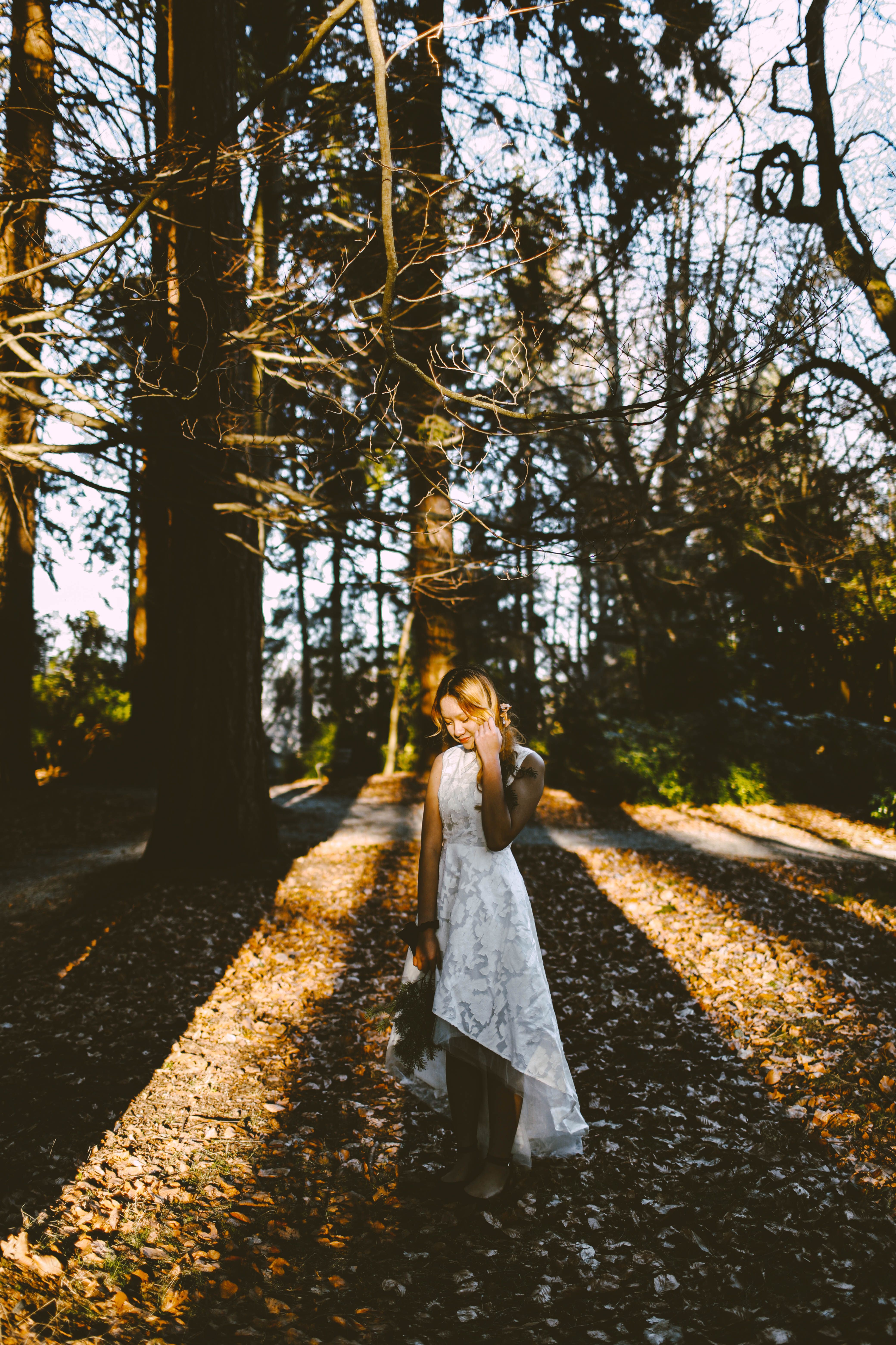 A Woman in White Dress Standing in the forest · Free Stock Photo