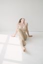 Woman sitting on floor in photo studio