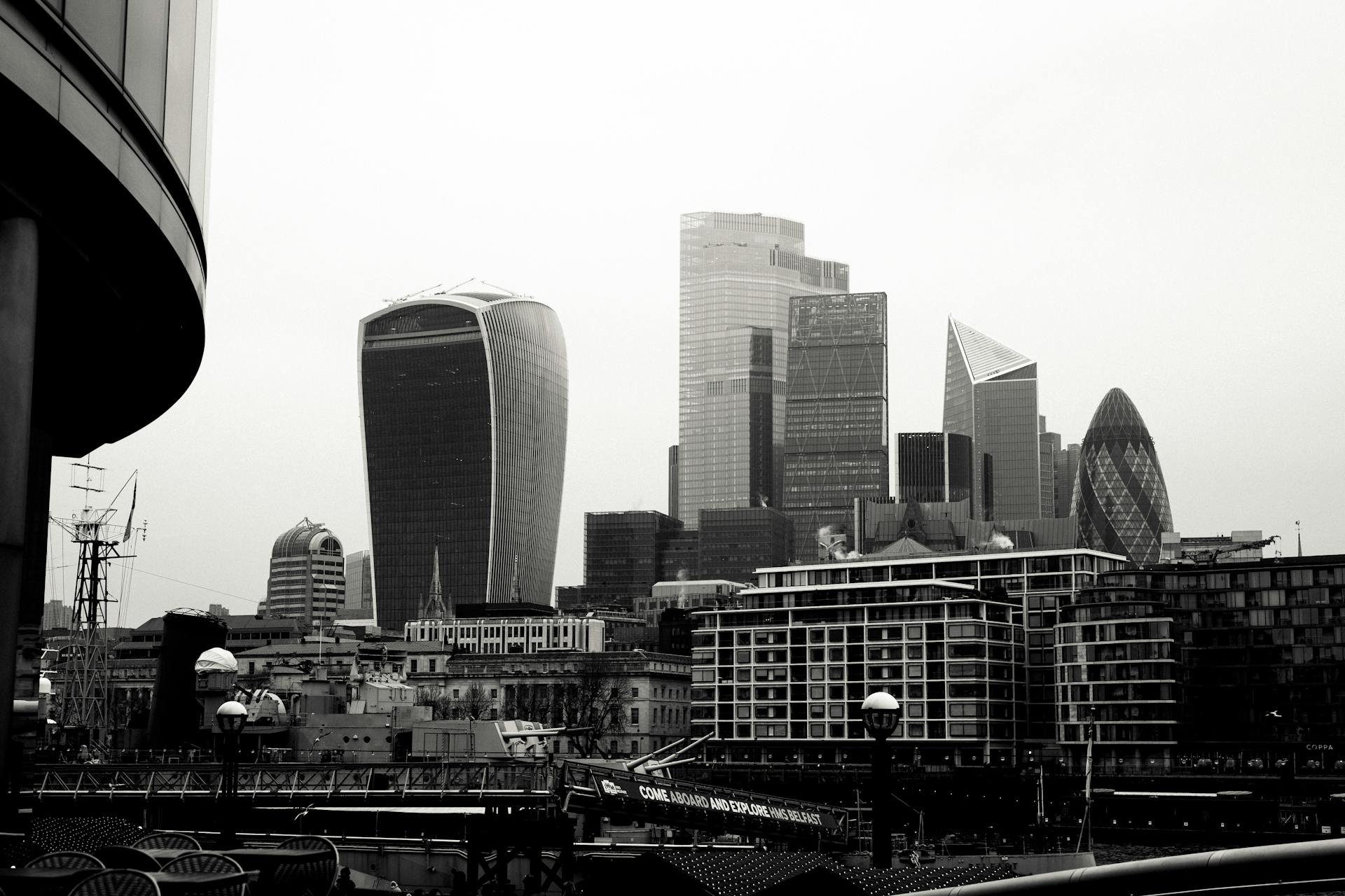 Black and white cityscape of London's iconic financial district with modern skyscrapers.