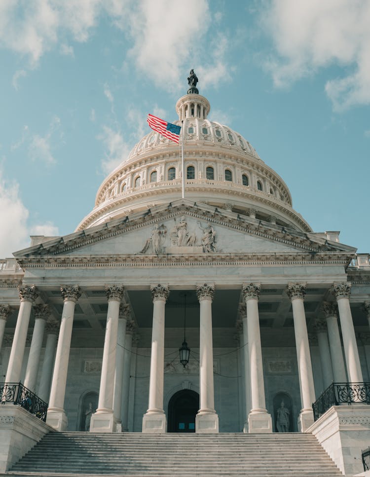 The US Capitol Building Under Cloudy Blue Sky