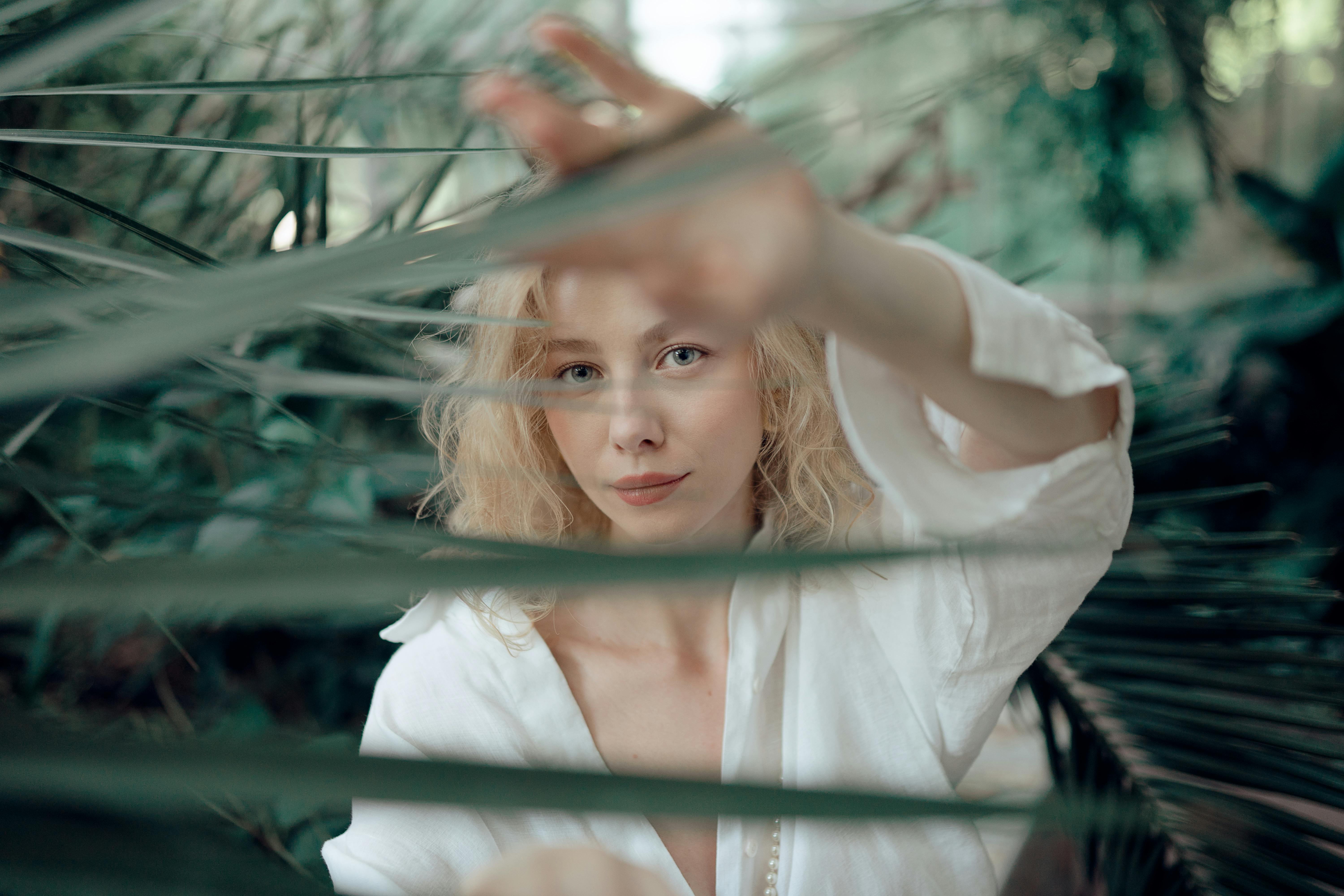 Woman behind a plant, not entirely visible