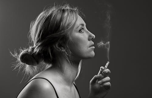 A Woman Holding a Burning Cigarette