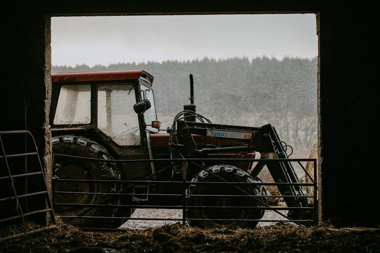 Tractor Parked Beside A Barn