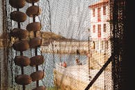 Close-up Photo of a Hanging Fishing Net with Floaters