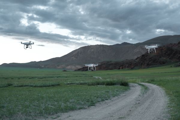 Aerial drone view of landscape with fields and mountains