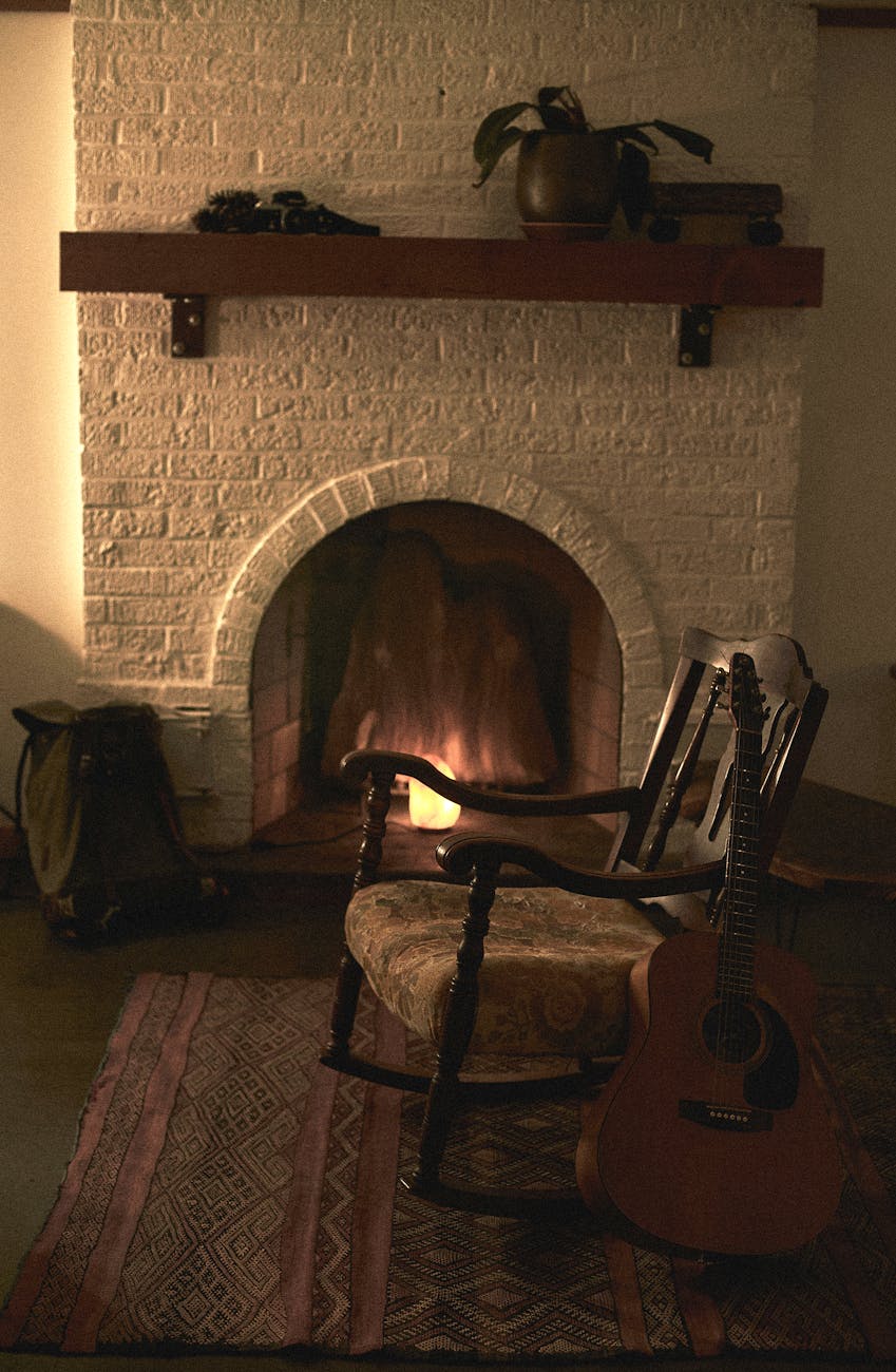 Brown Wooden Rocking Chair Near Fireplace · Free Stock Photo