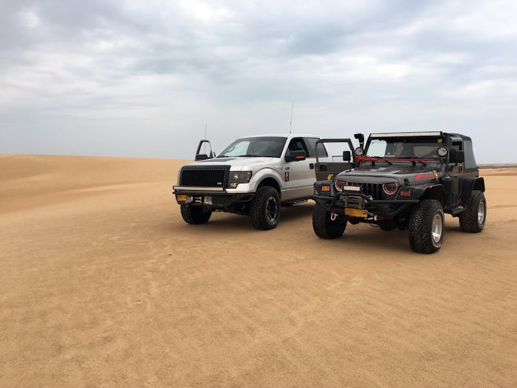 Jeeps Parked On A Desert