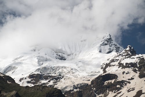 Free Snow Covered Mountain Under Cloudy Sky Stock Photo