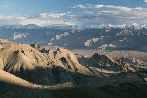 Free A stunning aerial view of a mountain landscape featuring snow-capped peaks and sweeping valleys. Stock Photo