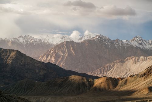 Free Stunning view of snow-capped peaks under a dramatic sky, capturing nature's beauty. Stock Photo