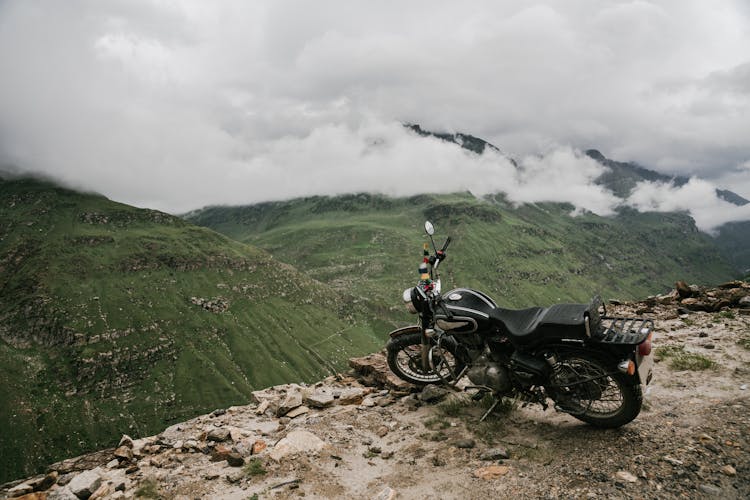 A Motorcycle Parked On A Cliff