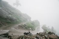 Black Motorcycle on Road Near Green Trees