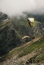 Paragliders Flying Near a Mountain