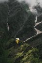 Yellow and Black Cable Car over Green and Gray Mountain