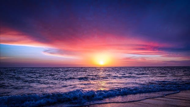 Breathtaking view of the ocean and sky during a vivid sunset, evoking tranquility and beauty.