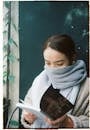 Woman in Light Blue Scarf Reading Book