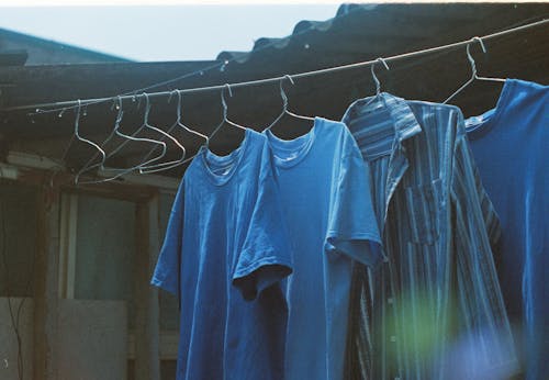 Blue Shirts Hanging on Rope Outside 