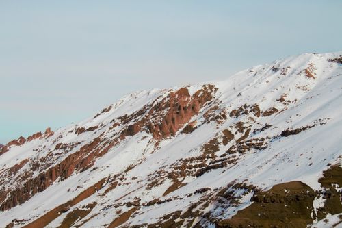 Free Snow-covered Andes mountain peak with rocky ridges in Lo Barnechea, Chile. Stock Photo