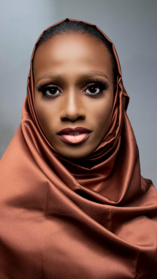Black woman with bright makeup in hijab