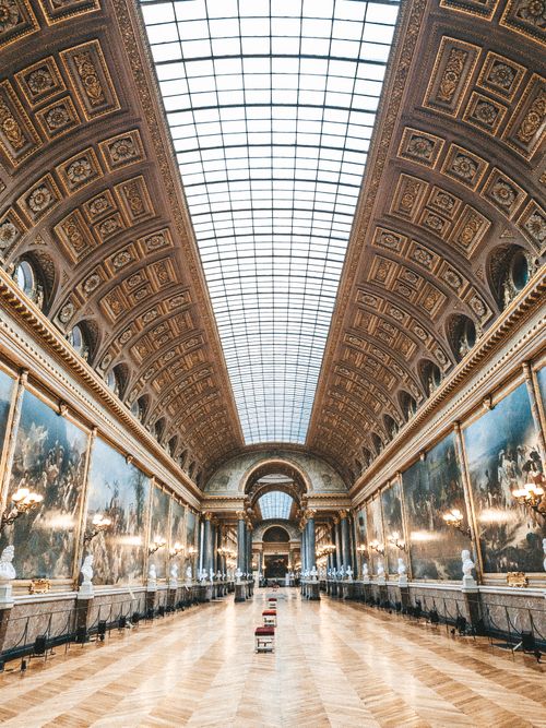 Free Majestic interior view of the Galerie des Batailles at the Palace of Versailles showcasing intricate architecture. Stock Photo