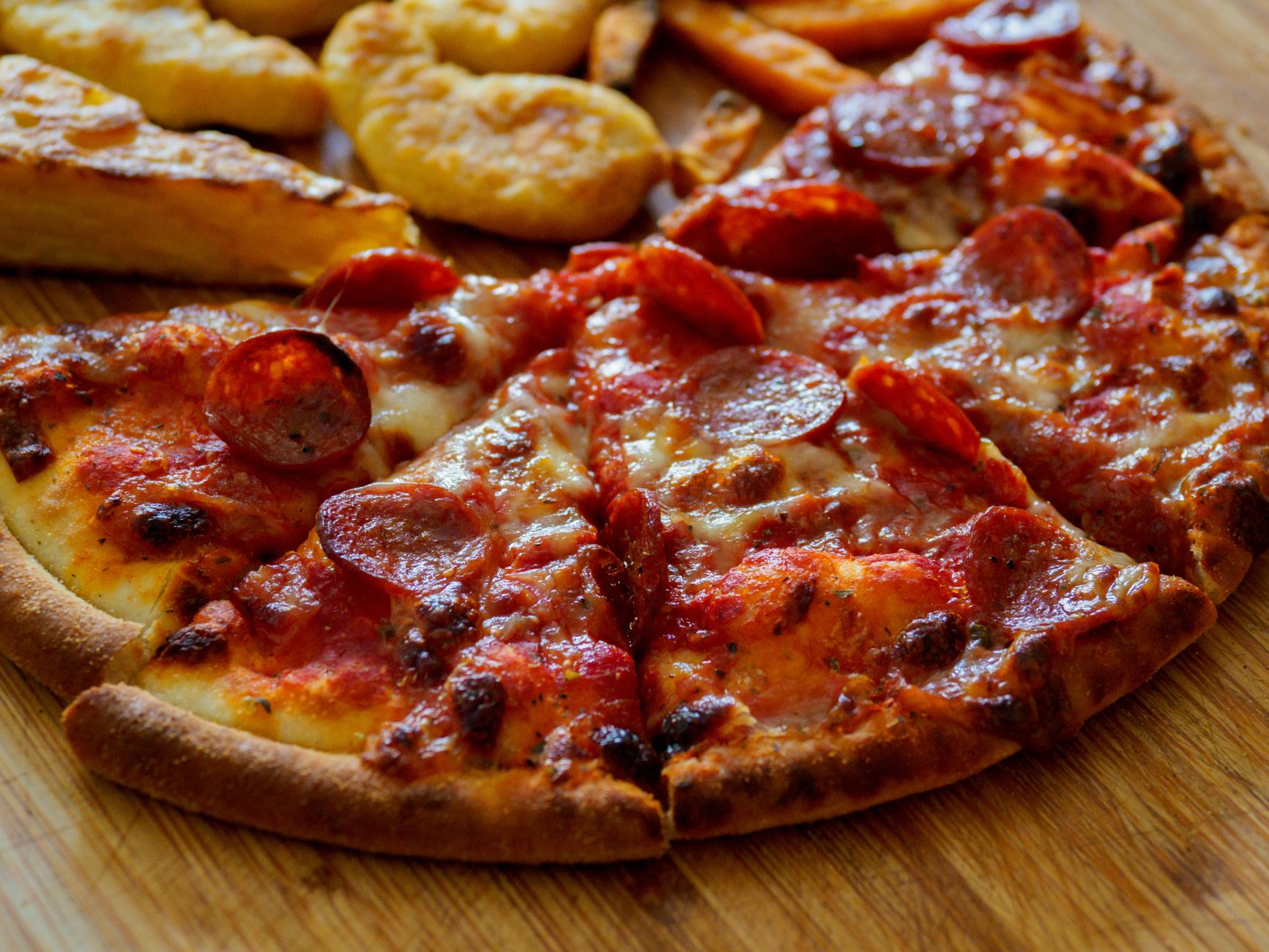 Close-up of crispy golden pizza pan crust slice
