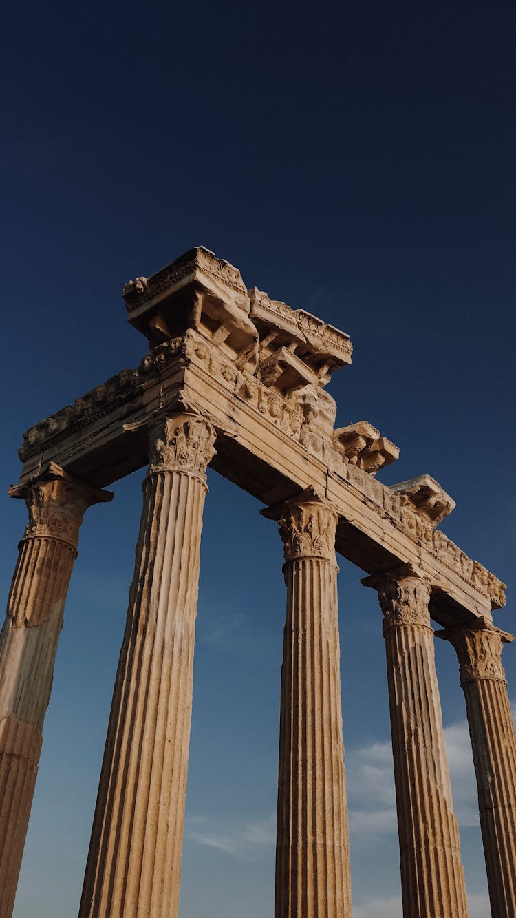 Old Columns Of Ancient Building Against Blue Sky