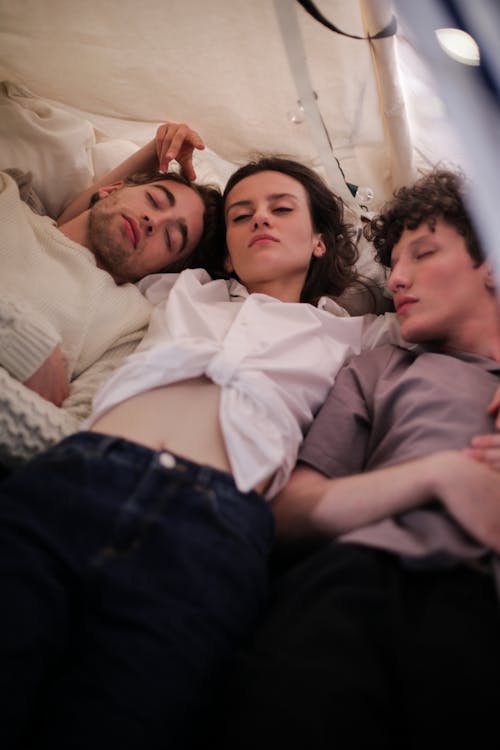 Man in Gray Shirt Lying Beside Woman in Gray Shirt