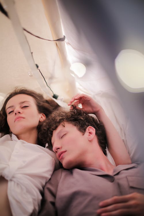 Free Woman in White Shirt Lying on Bed Stock Photo