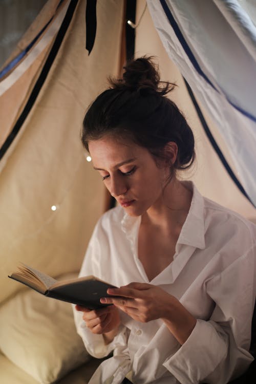 Woman in White Button Up Shirt Holding Black Smartphone