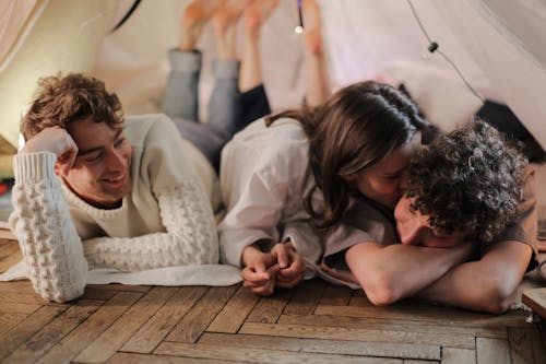 Man in White Dress Shirt Sitting Beside Woman in White Long Sleeve Shirt