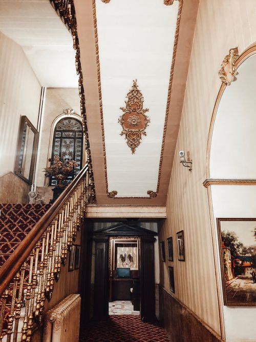 Free Perspective view of interior of hall with stairway with carpet and windows in stylish house Stock Photo