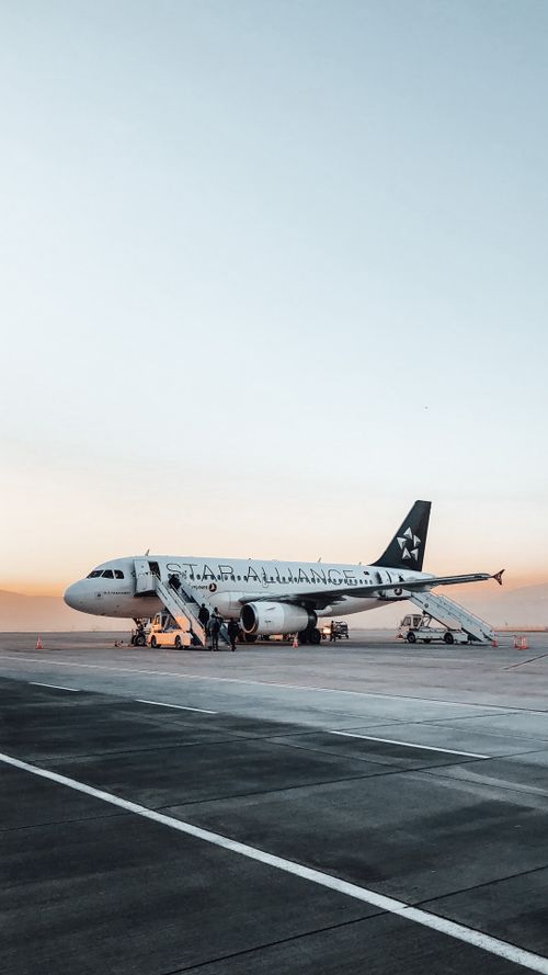 Free Airplane with opened doors and stairs places on empty asphalt road near  airport Stock Photo