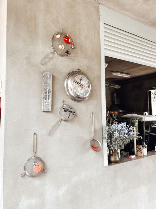 Free Interior of contemporary cafe with decorated walls and window in wall with rolling shutters with view of kitchen Stock Photo