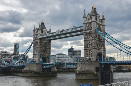 Free Iconic Tower Bridge in London under a cloudy sky, showcasing Victorian architecture. Stock Photo