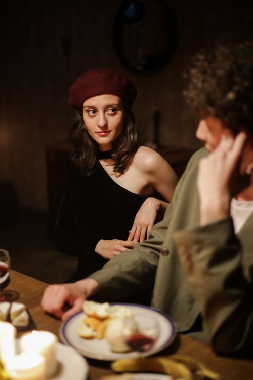 Free A romantic candlelit dinner between a couple enjoying an intimate evening indoors. Stock Photo