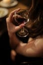 Woman Holding Clear Wine Glass