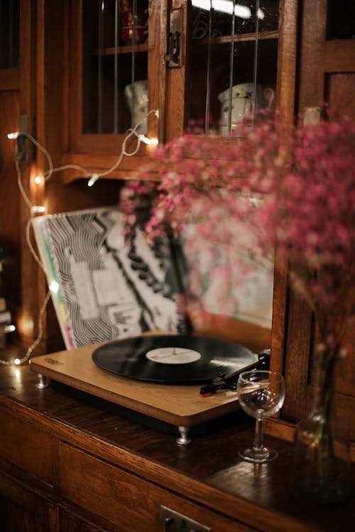 Black Vinyl Record on Brown Wooden Table